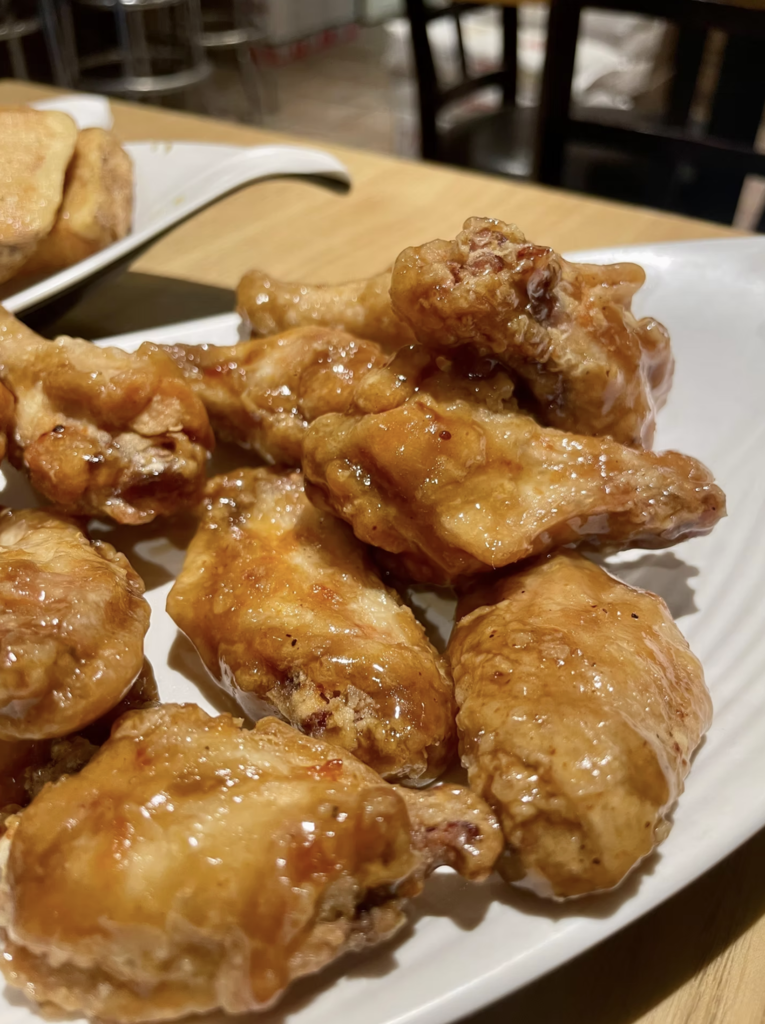 Crispy chicken wings coated in a delicious, glossy sauce.